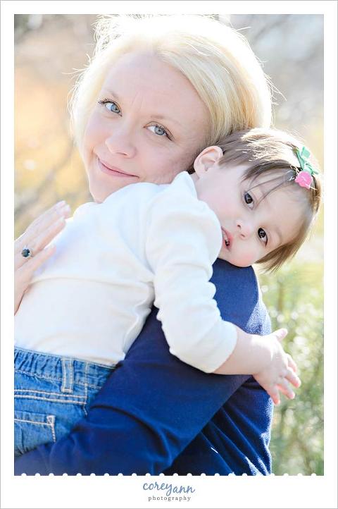 toddler patting her mom on her back