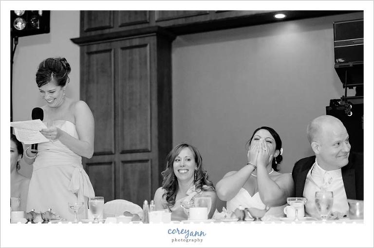 bride and groom laughing during toast during wedding reception at ahern's banquet center