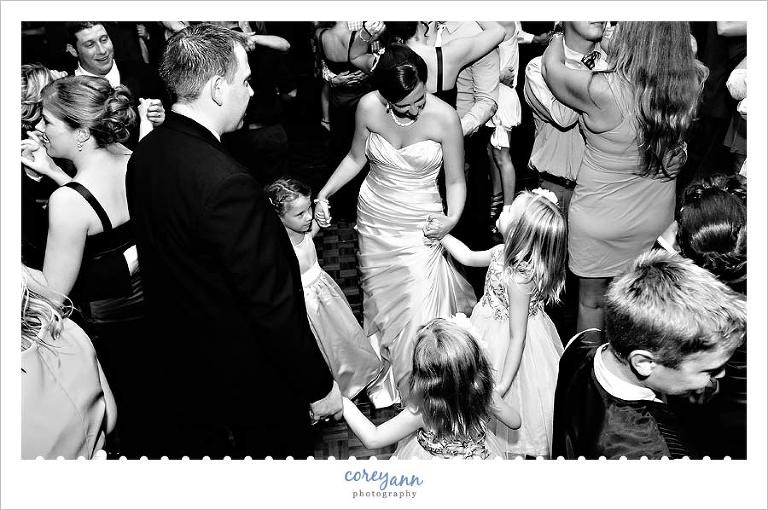 bride and groom dancing with flower girl at wedding reception