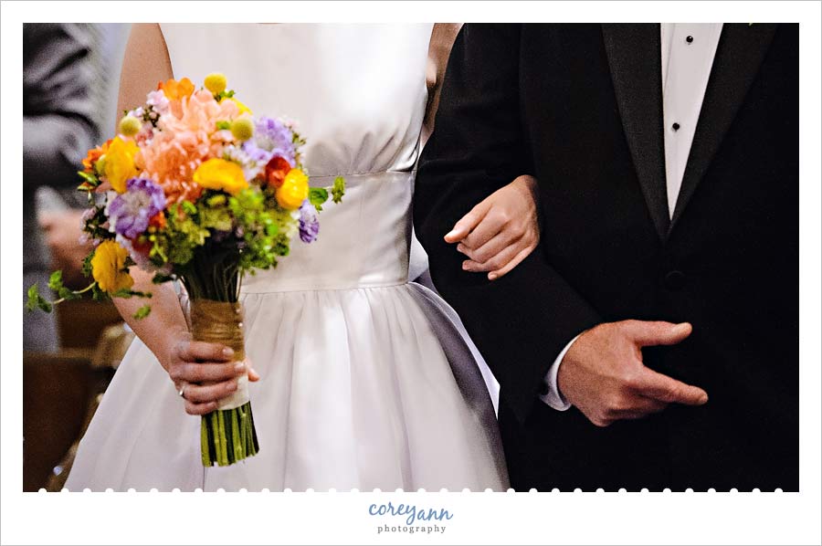 bride and father walking down aisle before wedding ceremony at old stone church
