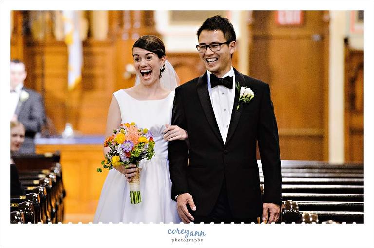 bride and groom grinning during recessional after wedding ceremony in cleveland ohio