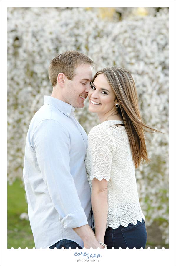 engagement session with tree blossoms at wade lagoon in cleveland ohio