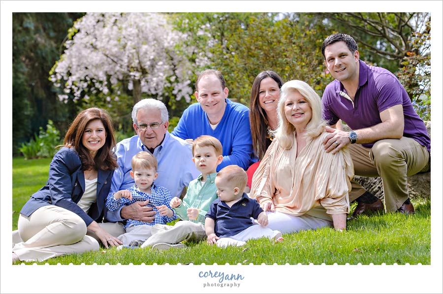 seated family portrait with blooming trees in northeast ohio