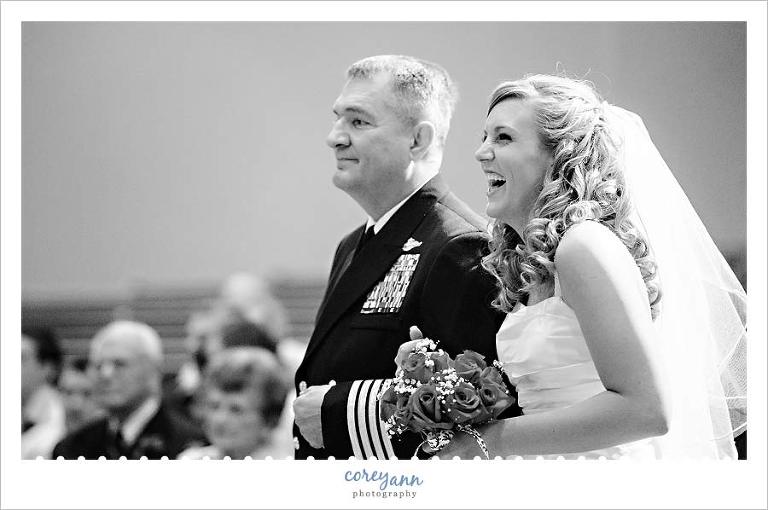 bride laughing when walking down the aisle with her father