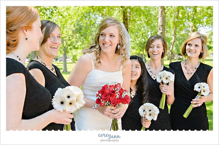 bridesmaids in black dresses with white bouquets