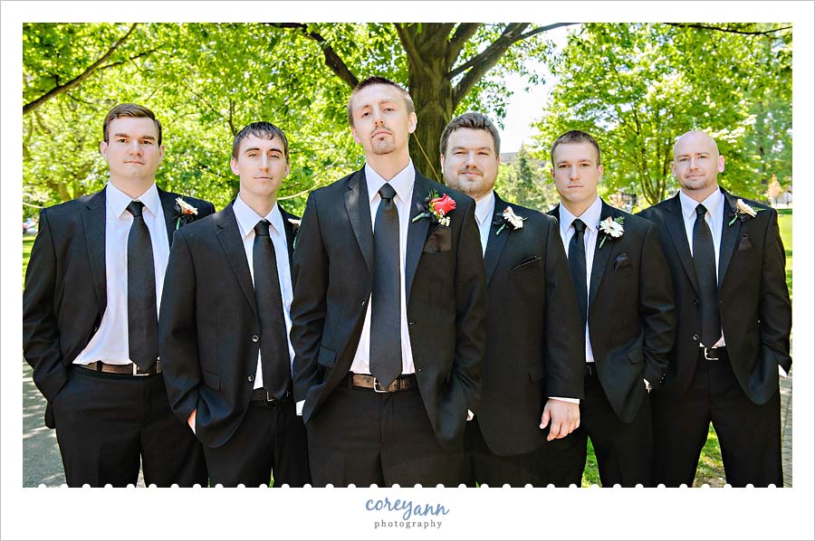 groomsman in black suits with black tie