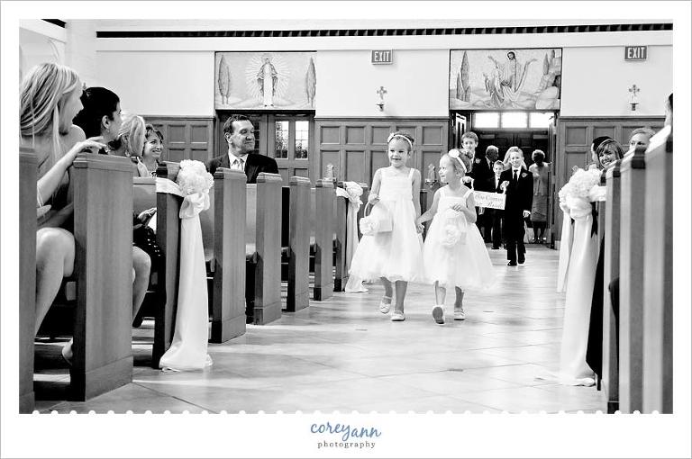flower girls walking down aisle at St Christopher in Rocky River