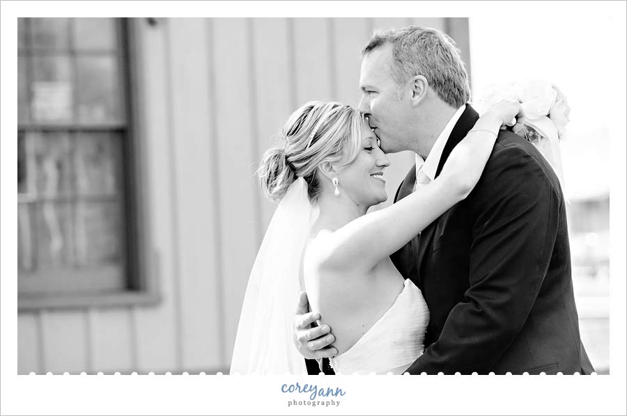 groom kissing bride on forehead