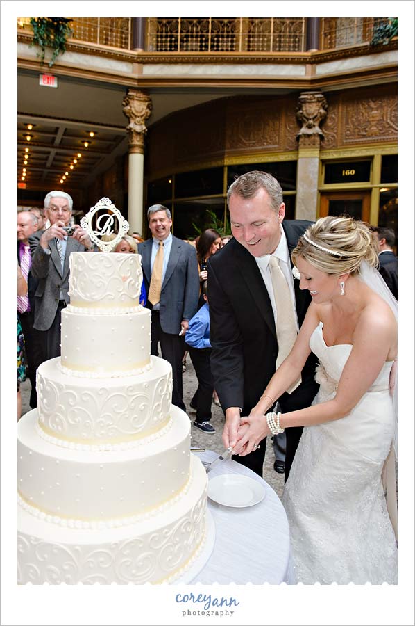 bride and groom cutting cake
