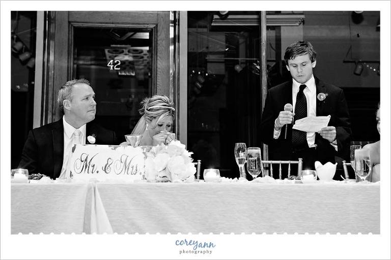 son giving best man toast at wedding reception
