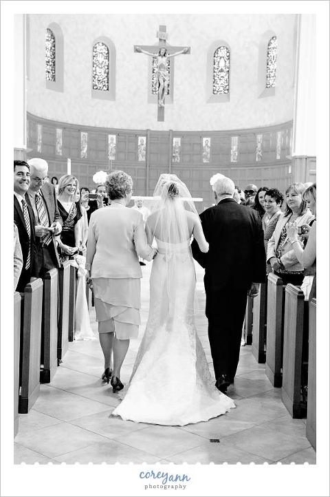 bride escorted down the aisle by both of her parents
