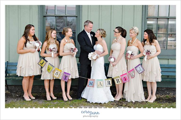 bridesmaids holding just married bunting