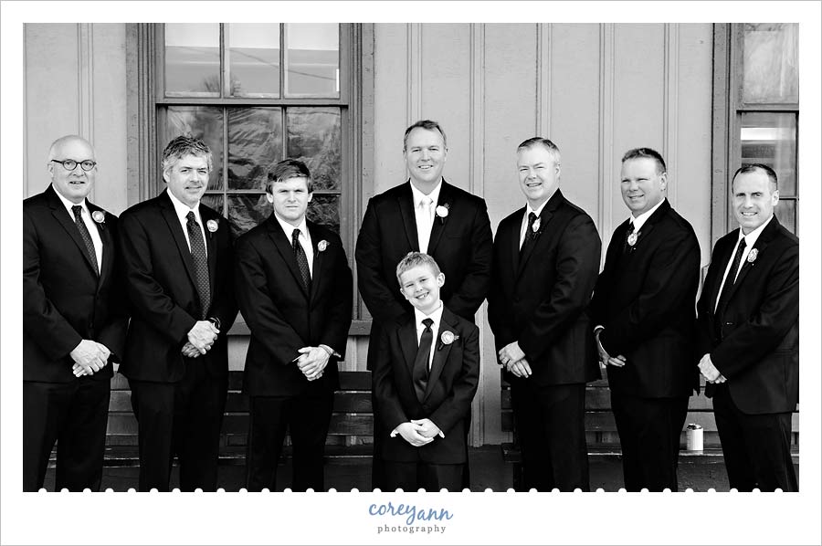 groomsman in front of train depot