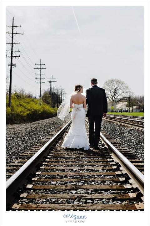 bride and groom walking along train tracks in olmsted falls ohio