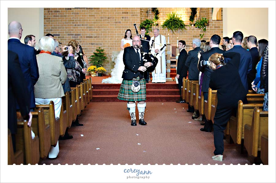 Unplugged Wedding guest standing in aisle to take a picture during wedding ceremony