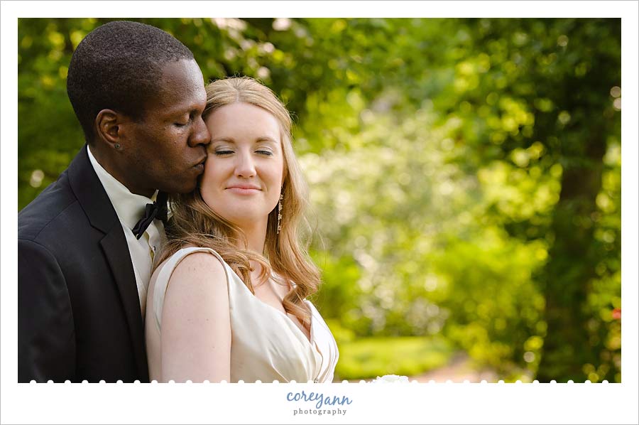 groom kissing bride's cheek