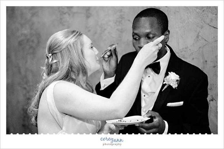 bride and groom eating cake at wedding reception in ohio