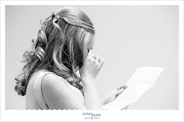 bride reading letter from groom prior to wedding ceremony
