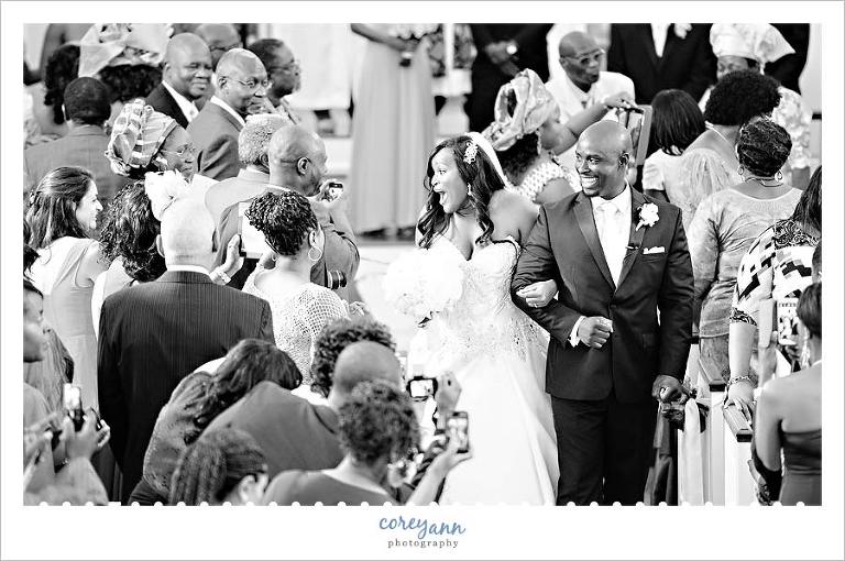 bride and groom recessing down the aisle after marriage ceremony