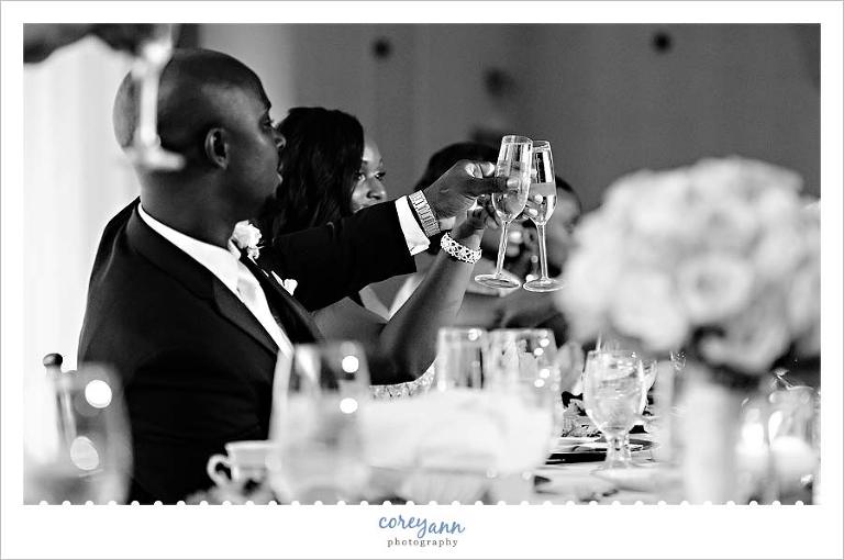 bride and groom toasting during speeches during wedding reception