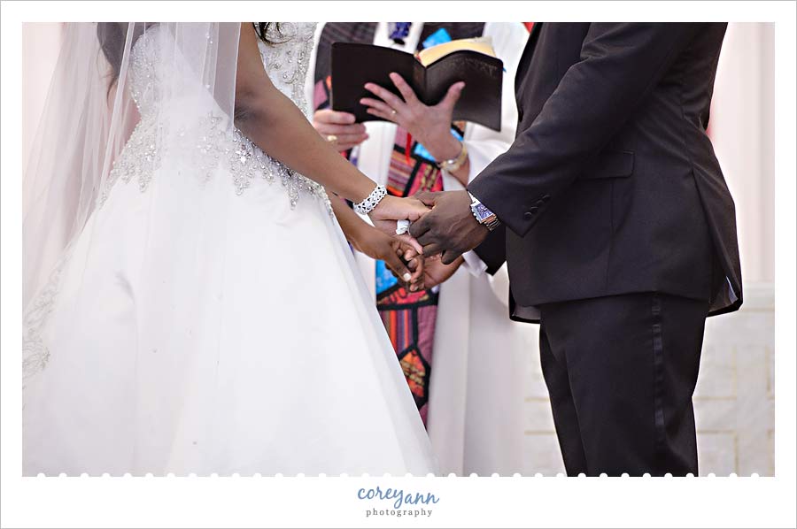 bride and groom holding hands during wedding ceremony