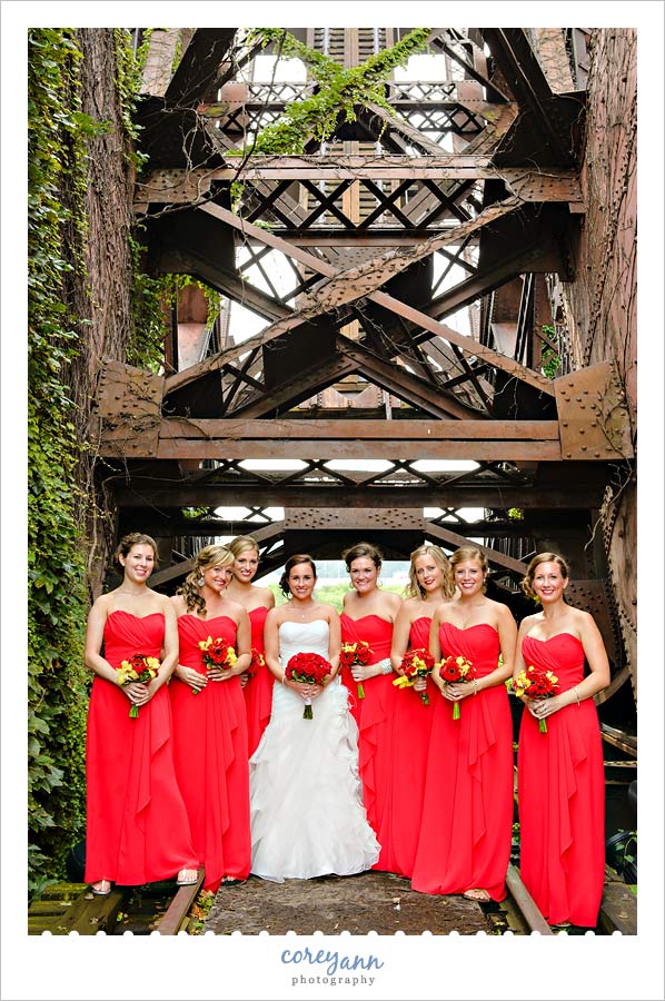 bridesmaids in long red dresses with red and yellow bouquets