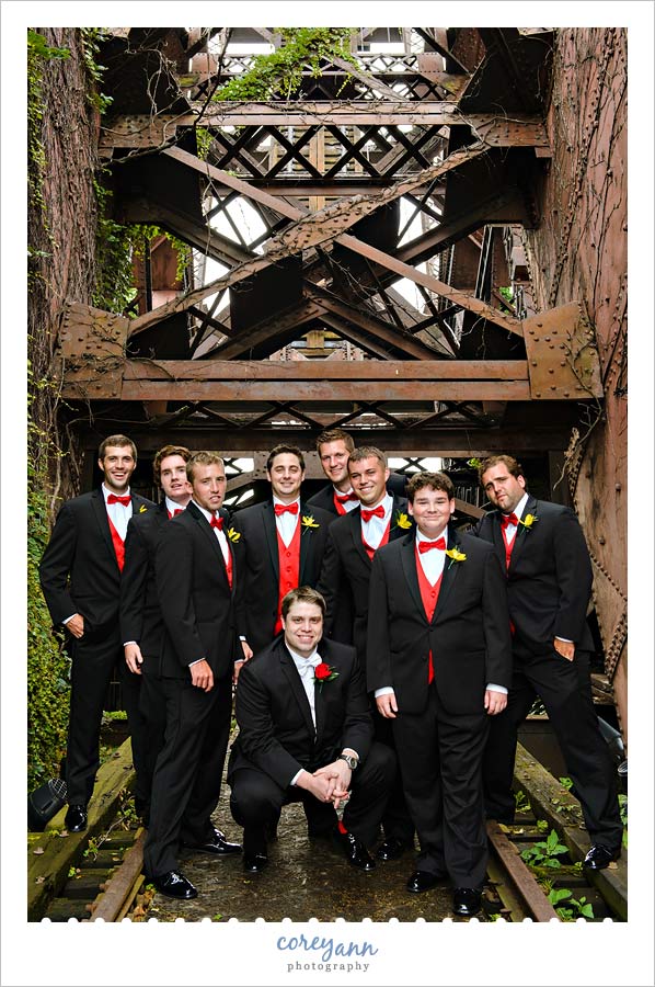 groomsman with red vests in black tuxes