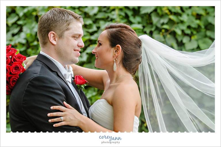 bride and groom with veil flowing behind her