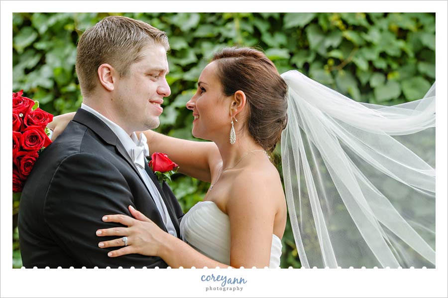 bride and groom with veil flowing behind her