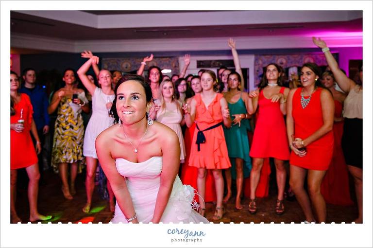 bride getting ready to throw bouquet at wedding reception