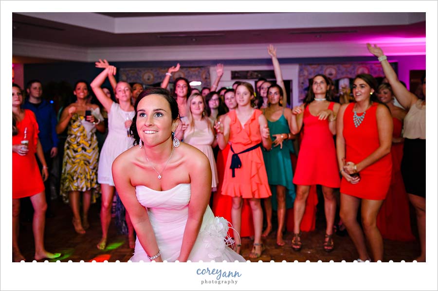 bride getting ready to throw bouquet at wedding reception