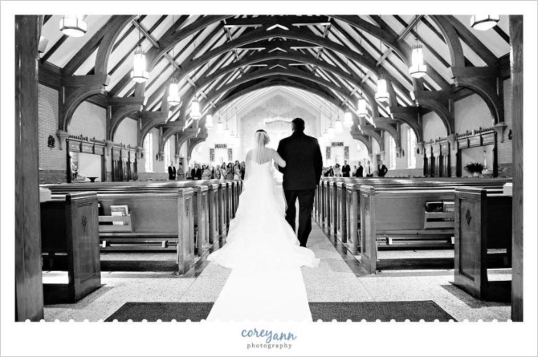 bride and father walking down aisle for wedding ceremony