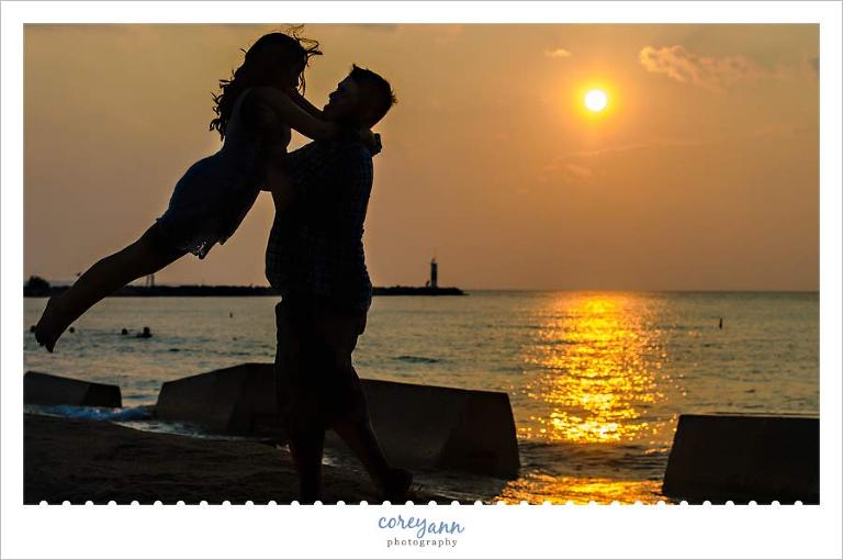 sunset engagement silhouette portrait in ohio on lake erie