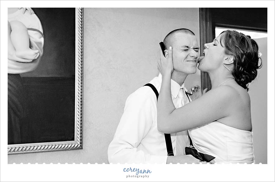 Kathleen and Derek's Canton Wedding bride licking cake off of groom's cheek