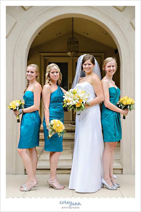 bridesmaids in teal dresses with yellow bouquets