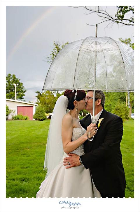 bride and groom portrait with rainbow