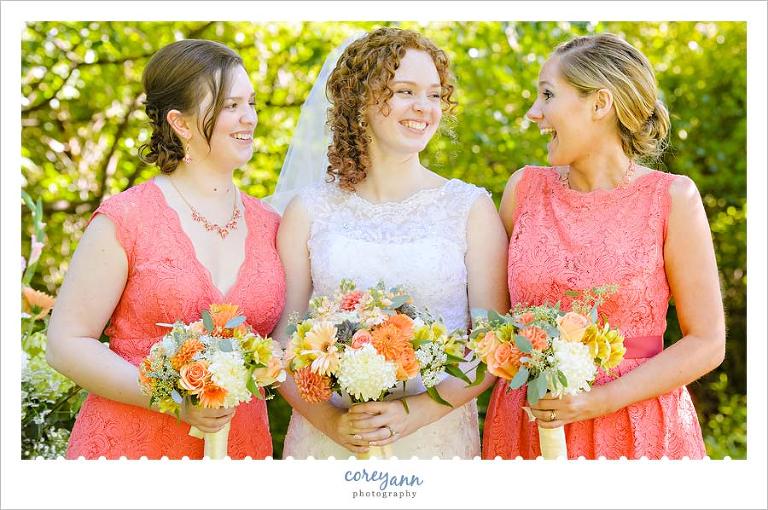 coral lace bridesmaid dresses with orange green and white bouquets