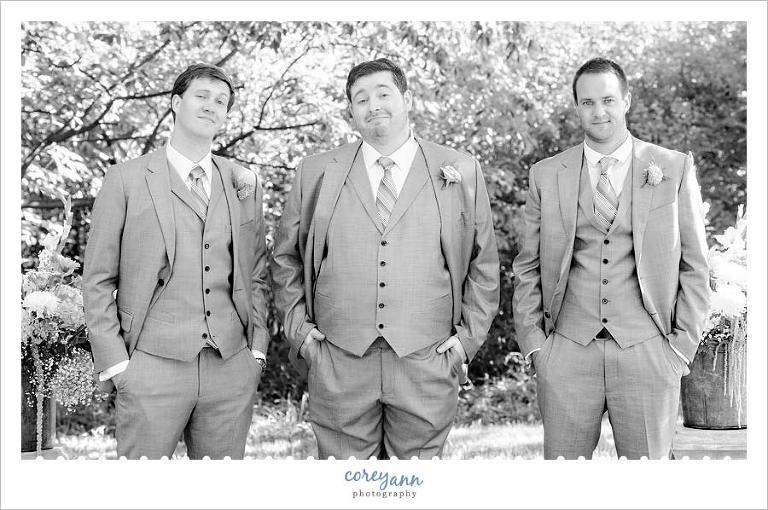 groom and groomsman in a three piece suit