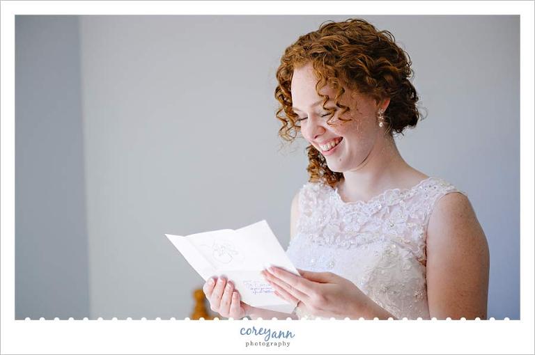 bride reading letter from groom on day of wedding