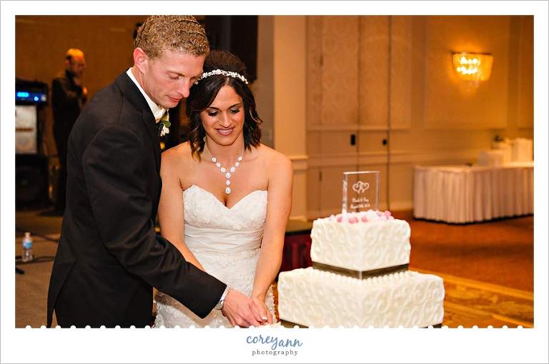 cutting the cake during wedding reception in akron