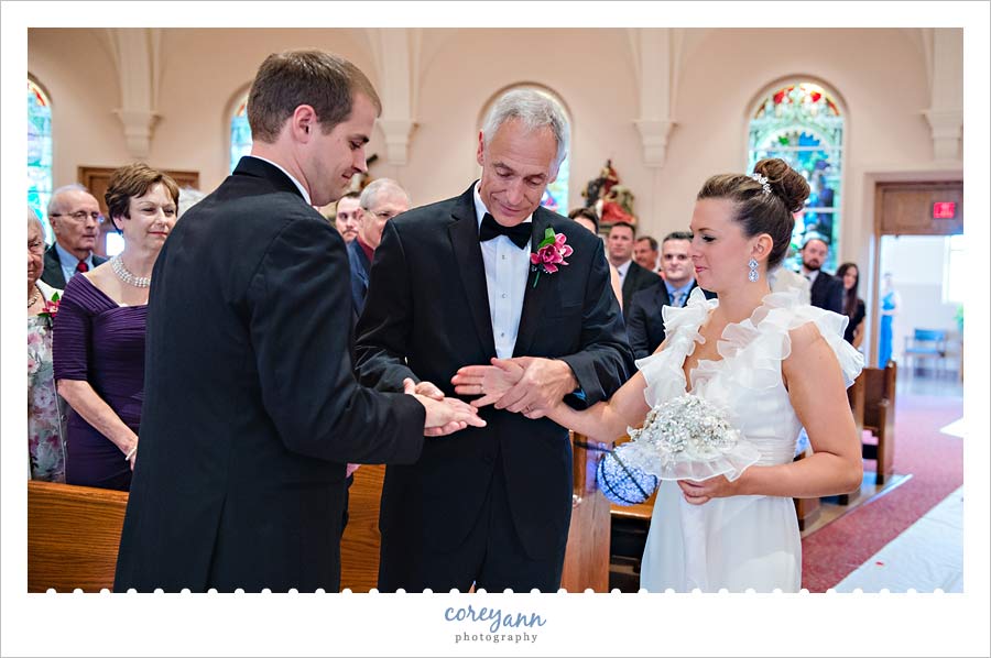 father handing over bride to the groom at wedding ceremony