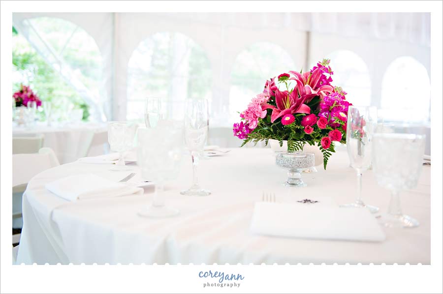 wedding reception in a tent with pink centerpiece