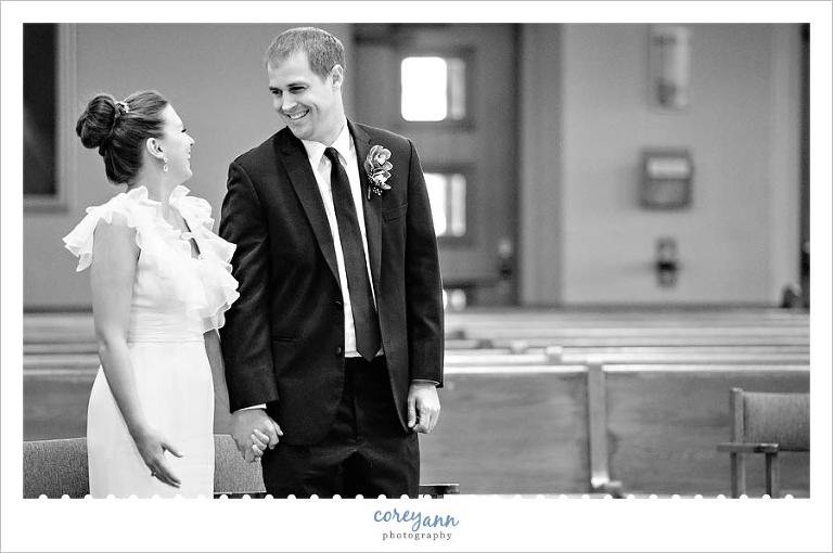 bride and groom smiling during wedding ceremony at st paul's in north canton