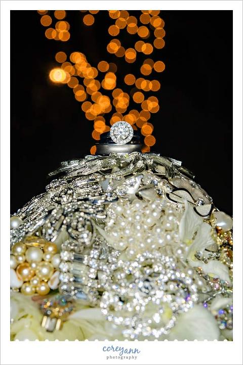 wedding rings on top of wedding bouquet