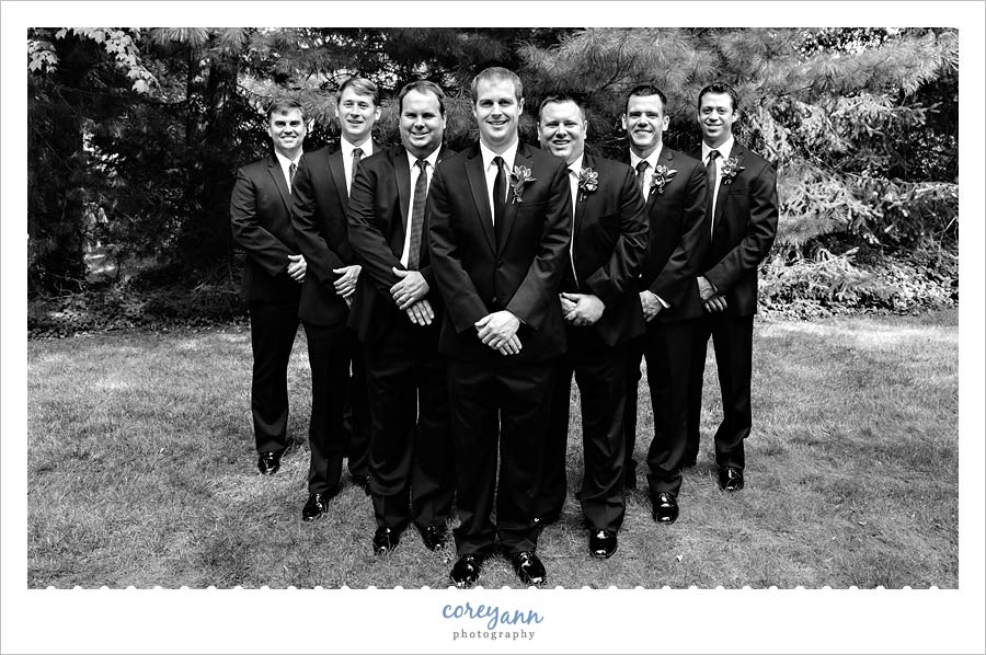 groomsman in black by vera wang suits at wedding