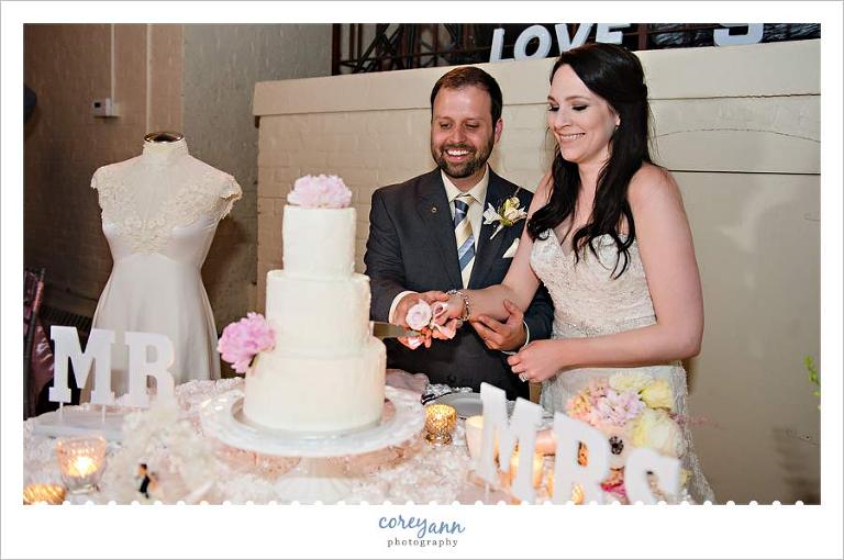 bride and groom cutting cake by west side bakery in akron