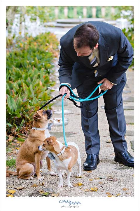 groom waiting with dogs for first look of bride