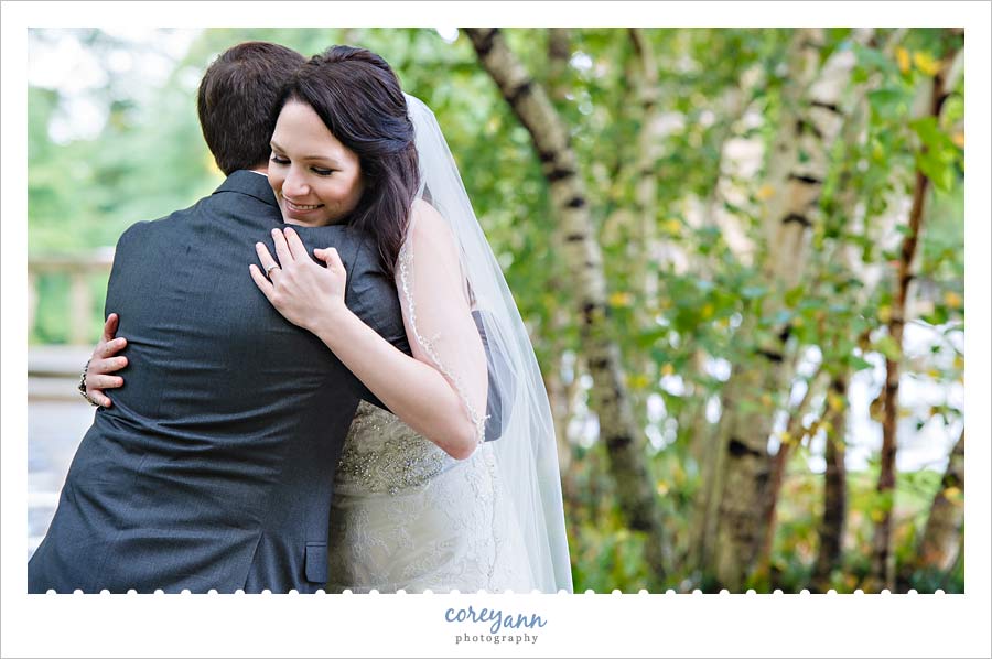 bride and groom embracing after first look 