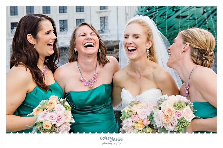 bridesmaids in jade dresses with pink bouquets