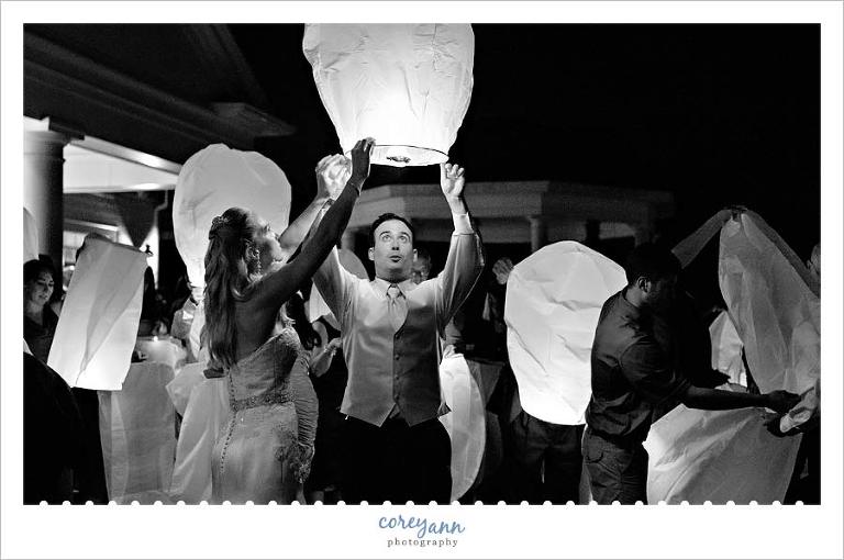 bride and groom lighting a wish lantern